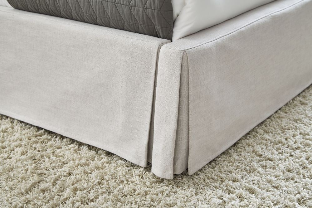 Hera Upholstered Skirted Storage Panel Bed in Oatmeal